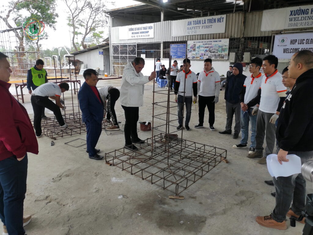 Recruiters inspecting the durability of the steel frame after candidates complete the skills test