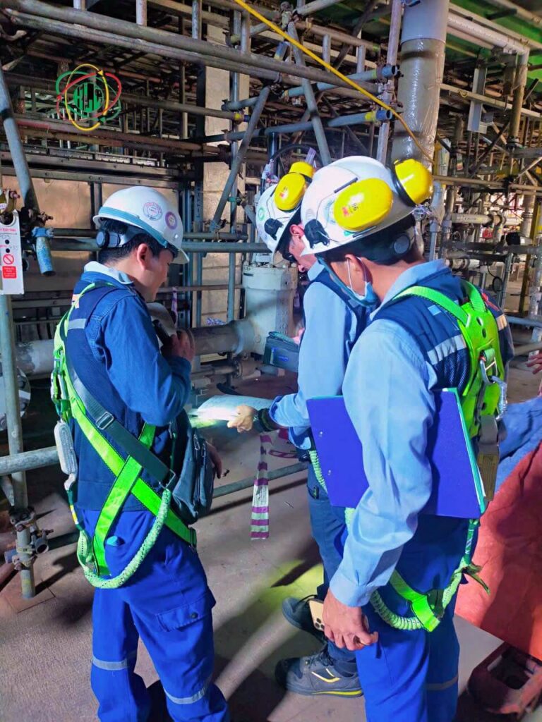 Vietnamese technicians operating factory machinery