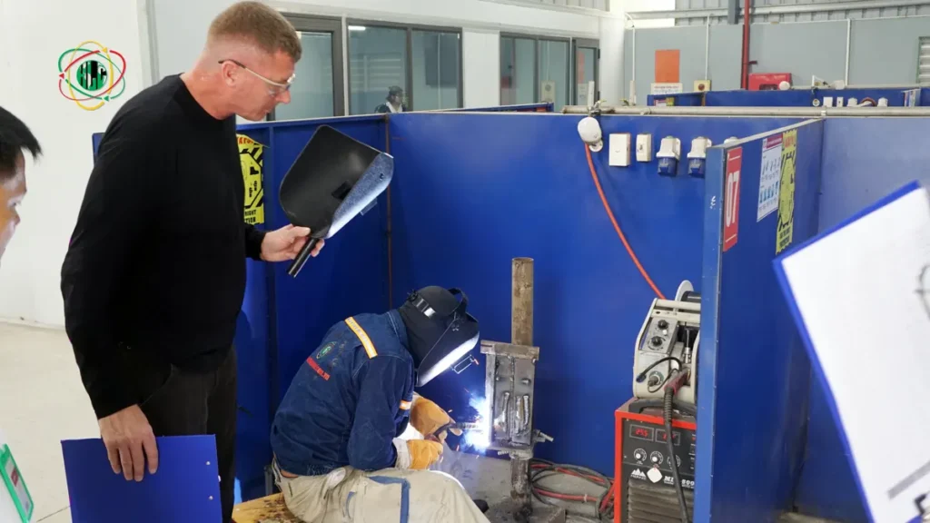 Vietnamese technical workers completing a welding assessment in a workshop